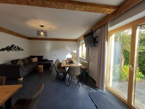 a living room with a couch and a table at Hochtenn Lodge in Zell am See - Steinbock Lodges in Zell am See