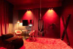a red living room with a couch and two chairs at Évasion intime : Love Room de luxe à Cannes in Cannes