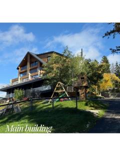a house with a playground in front of it at The Pines Bucegi Lodge in Bran
