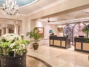 a lobby of a hotel with flowers and a salon at Fairmont The Norfolk in Nairobi