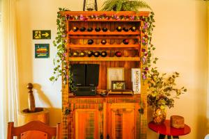 a room with a shelf with wine bottles at Pousada Jardim da Mantiqueira in Monte Verde +20 photos