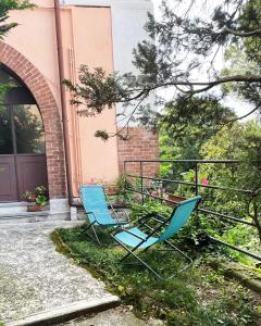 two blue chairs sitting outside of a building at Alture di Como-splendido appartamento in Como