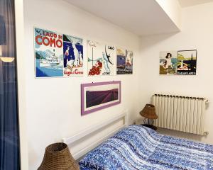 a bedroom with posters on the wall at Alture di Como-splendido appartamento in Como
