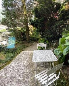 two chairs and a table and a table and bench at Alture di Como-splendido appartamento in Como +22 photos