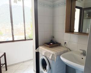 a bathroom with a washing machine and a sink at Alture di Como-splendido appartamento in Como