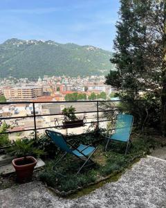 a couple of chairs sitting on top of a balcony at Alture di Como-splendido appartamento in Como