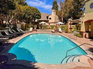 ein großer Pool mit Liegestühlen um ihn herum in der Unterkunft Newport Coast Bungalow in Newport Beach