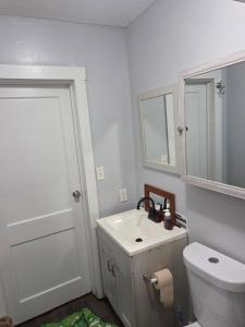 a bathroom with a sink and a toilet and a mirror at Yellow Mellow in Jackson