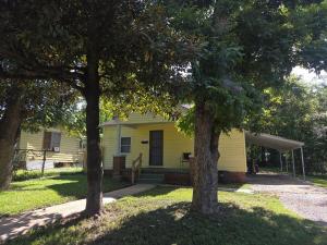 a yellow house with two trees in front of it at Yellow Mellow in Jackson