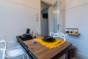 a dining room table with a yellow napkin and glasses at Noir Luxury 1 bedroom Atelier in Mesochórion +9 photos