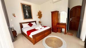 a bedroom with a bed and a table and a mirror at lake hill view in Kintamani