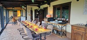 a dining room with a long table and chairs at Villa Fonte in Ferrere