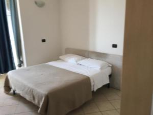 a bedroom with a bed with white sheets and pillows at Europa House in Padova