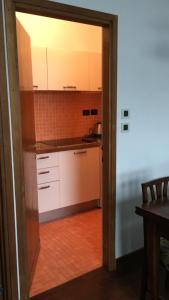 a kitchen with white cabinets and a table at Europa House in Padova