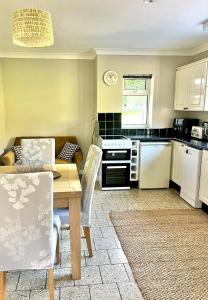 a kitchen with a table and a dining room at Ty Newydd in Llangyniew