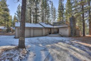 a house in the woods with a tree at 11 Pine Mt in Sunriver