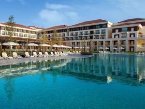 a swimming pool in front of a resort at Rixos Water World Aktau - Theme Park Free Access in Aktau