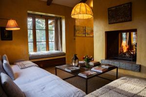 a living room with a couch and a fire place at Yellow House 3-bedroom Villa In Nature in Naivasha