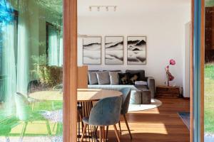 a living room with a table and a couch at Laax Alpine Lodge by Quokka 360 - terrace with magnificent mountain views in Laax