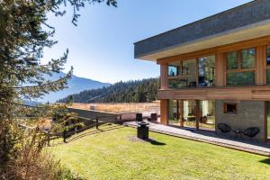 a house with a view of the mountains at Laax Alpine Lodge by Quokka 360 - terrace with magnificent mountain views in Laax