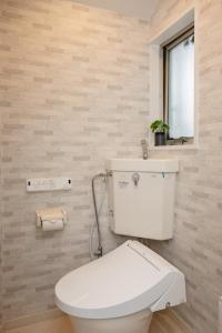 a bathroom with a white toilet and a window at Darin博多 in Fukuoka +28 photos
