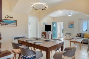 a living room with a table and chairs at Aegean Villas Ios in Ios Chora