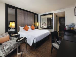 a hotel room with a bed and a couch at Mövenpick Hotel Sukhumvit 15 Bangkok in Bangkok +195 photos