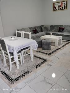 a living room with a table and chairs and a couch at Vila Marini in Lin