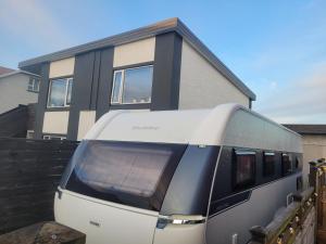 a train is parked in front of a house at Freyja Caravan in Akranes