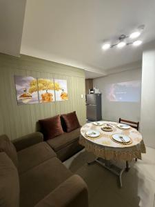 a living room with a couch and a table at City view in Manila