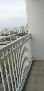 a white balcony with a view of a city at City view in Manila