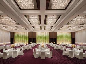 a banquet hall with white tables and chairs at Fairmont Wuhan in Wuhan +101 photos