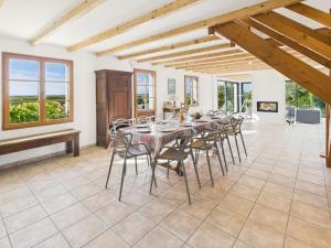a dining room with a long table and chairs at Longère - 10 personnes - Vue mer in Tréguennec