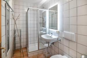 a bathroom with a sink and a shower and a toilet at Naturferienwohnung Am Lautergarten in Indelhausen +51 photos