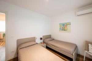 a bedroom with two beds in a room at Summer Villas in Lignano Sabbiadoro