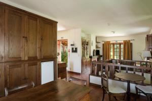 a kitchen and dining room with a table and chairs at Quinta do Pomarinho - by RowdHouses in Arouca