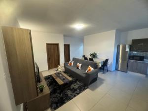 a living room with a couch and a kitchen at Room cozy in San Julian 4 in St Julian's +7 photos