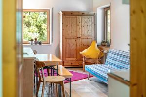 a living room with a couch and a table and chairs at Naturferienwohnung Am Lautergarten in Indelhausen
