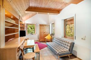 a living room with a couch and a table at Naturferienwohnung Am Lautergarten in Indelhausen