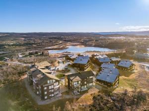 an aerial view of a large house with a river at Kikut Panorama Geilo Ski-in Ski-out in Geilo