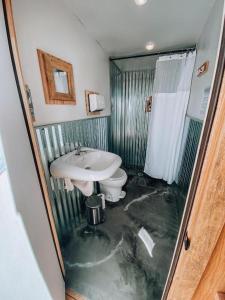a flooded bathroom with a sink and a toilet at Starlight Olympic Glamping in Port Angeles