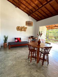 a living room with a table and chairs and a couch at Divina Casa in Itacaré