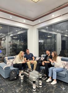 a group of people sitting on couches in a room at Jungle Backpackers View in Vang Vieng