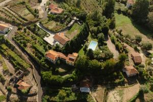 an aerial view of a house with a yard at Quinta do Pomarinho - by RowdHouses in Arouca