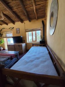 a room with two beds and a television in it at Casa de Altura in Tilcara