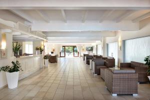 a lobby of a hotel with couches and chairs at Cala Fiorita in Agrustos +127 photos