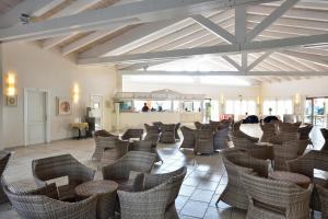 a room filled with wicker chairs on a tile floor at Cala Fiorita in Agrustos