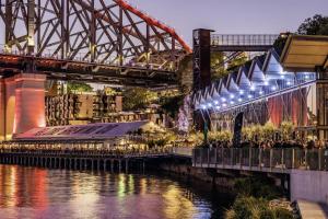 a bridge over a river next to a river at Mid-Century Luxe - Story Bridge & River Views in Brisbane +11 photos