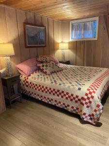 a bedroom with a bed in a wooden room at Sunset Serenity - Incredible Home On Lake Bluff! in Frankfort