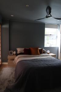 a bedroom with a large bed and a window at Mid-Century Luxe - Story Bridge & River Views in Brisbane